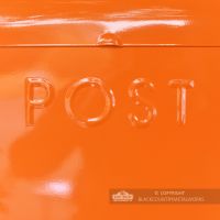 Close Up Of Embossed Lettering On Orange Post Box