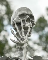 Close up of intricate face and hand detail on skeleton garden sculpture