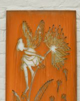 Close up of intricate cut out fairy detail on rustic garden wall art
