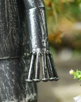 Close up of hand on Small Tin Man Garden Sculpture