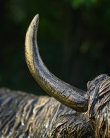 Close up of gold horn detail on highland cow outdoor statue