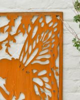 Close up of intricate cut out fairy detail on rustic garden wall art