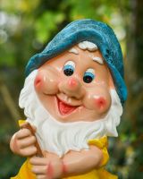 Close up of intricate face detail on colourful garden gnome sculpture