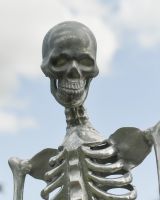 Close up of intricate face detail on silver skeleton garden sculpture