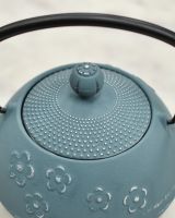 Close up of intricate detailing on lid and black handle detail on Blue & Silver Uwade Style Teapot with Floral Detailing