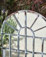 Close up of rustic finish on metal garden mirror