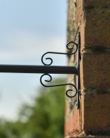 Close up of ornate mounting bracket on Beehive Weathervane