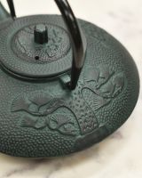 Black Handle Up on Dark Green Bamboo Design Teapot 