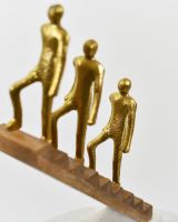 Close up of gold aluminium people detail on interior ornament
