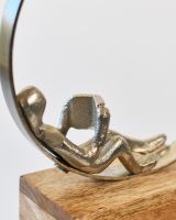 Close up of person reading on cast aluminium home decor sculpture