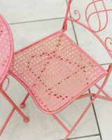 Close up of intricate seat detail on gold dusted garden bistro set
