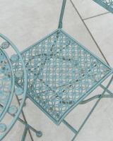 Close up of intricate seat detail on garden two seater table and chairs set