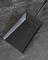 Close up of shovel in fireside brush and shovel set