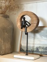 Angled view of black figure on home accessory