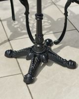 Close up of ornate table leg detail on outdoor two seater dining set