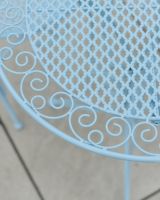 Close up of ornate detail on outdoor two seater table and chairs set