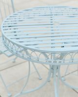 Close up of ornate table top detailing on garden two seater bistro set
