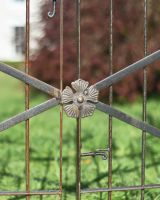 Close Up Of The Flower Detail On The Gate Of the natural Steel Garden Rose Arch