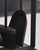 Close up of spade and brush on black fireside companion set