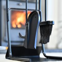 Close up of fireside tools on modern black companion set