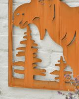 Close up of intricate cut out tree detail on rustic garden wall art