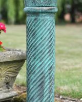 Close up of verdigris finish on garden sundial column