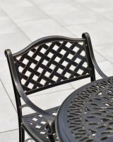 Close up of chair lattice detail on 5 piece outdoor dining set
