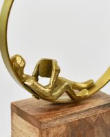 Close up of person reading on Cast Aluminium and Mango Wood Home Decor Sculpture 