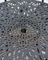 close of up table top detail with umbrella hole on round aluminium dining table