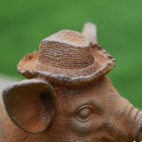 Close up of straw hat on Pig Sculpture 