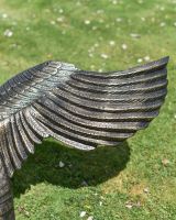 Close up of Black and Gold "Conqueror" Swan Sculpture Wing