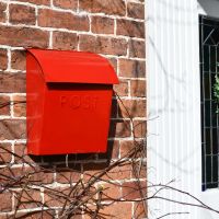 Bright Red Contemporary Post Box in Situ Next to the Front Door