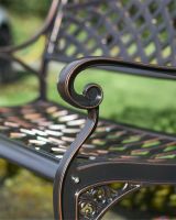 Close up of copper bench with scrolled arm 