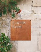 Corten Steel Square House Name Sign in Situ on a Sandstone Wall