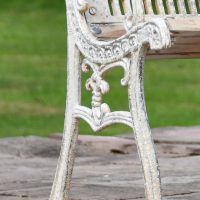 Close up of Antique Cream Cast Iron Bench