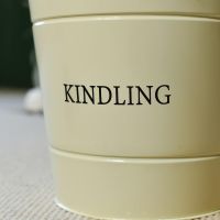 Close-Up of "KINDLING" Text on Log Store Bucket