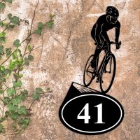 Cyclist Iron House Number Sign in Situ on a Rustic Wall 