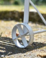 Close up of intricate wheel detail on three seater garden bench