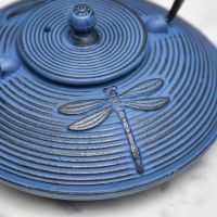 Close-Up of Dragonfly Design on Dark Blue Cast Iron Teapot