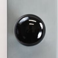 Above View of the Black Ceramic Door Knob on a Grey Door