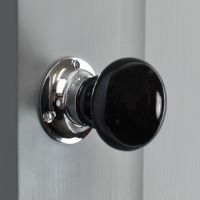 Black Ceramic Door Knob on a Grey Door