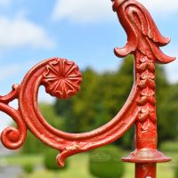 Distressed Red Ornate Scroll Work On Lamp Post