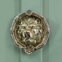 Polsihed Brass round Regal lion door knocker on Pastel green door