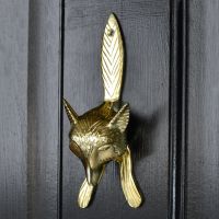 Polished Brass Fox door knocker on black wood door