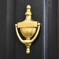 Gold Anodised Urn Door Knocker on a Black Door
