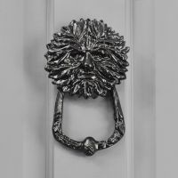 Green man door knocker on front door