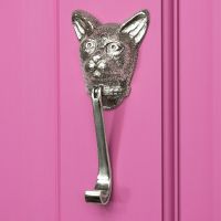 Bright Chrome Cat head door knocker on bright Pink Door