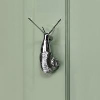 Bright Chrome Snail Door Knocker on Green Door