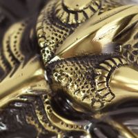 Detailed image of dragon scales on solid brass door knocker