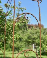 Close up of ornate scrollwork detail on rose arch 